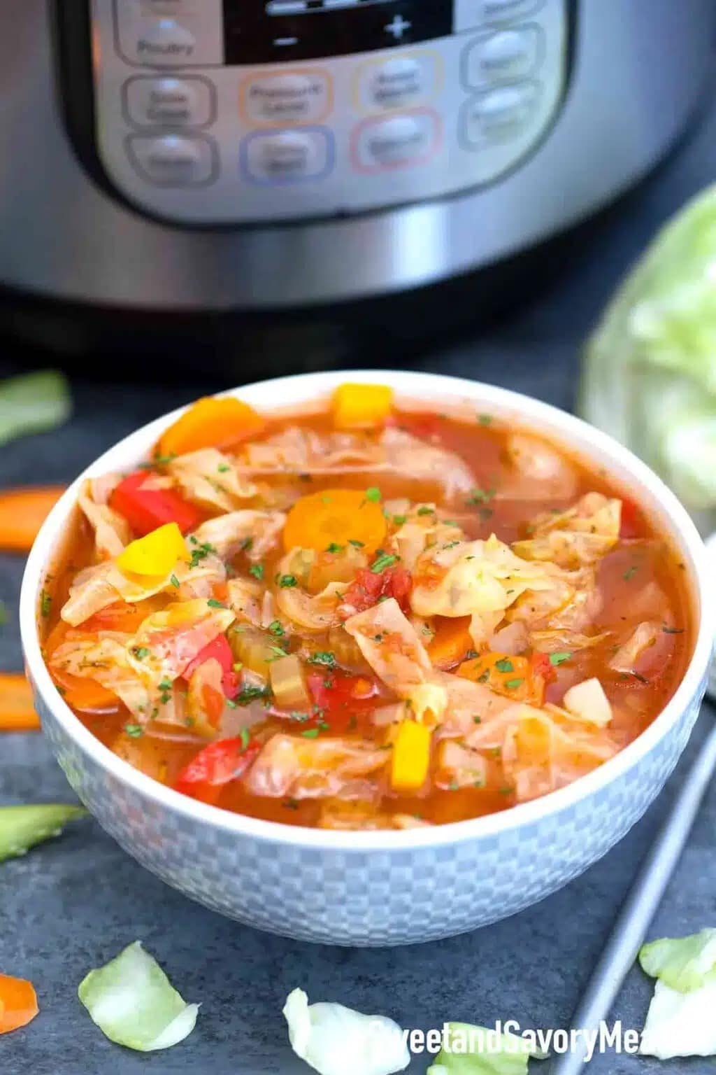 Bowl of homemade Instant Pot Cabbage Soup with carrots, chopped bell peppers, sliced celery and green beans