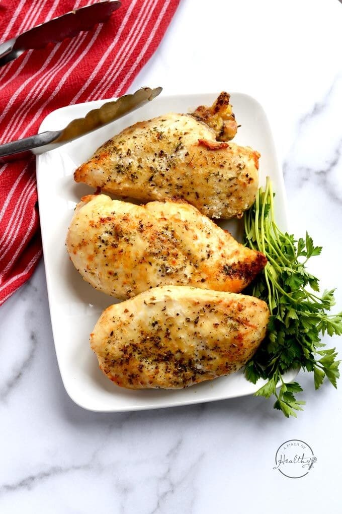 Three Air Fryer Chicken Breast with fresh parsley on the side