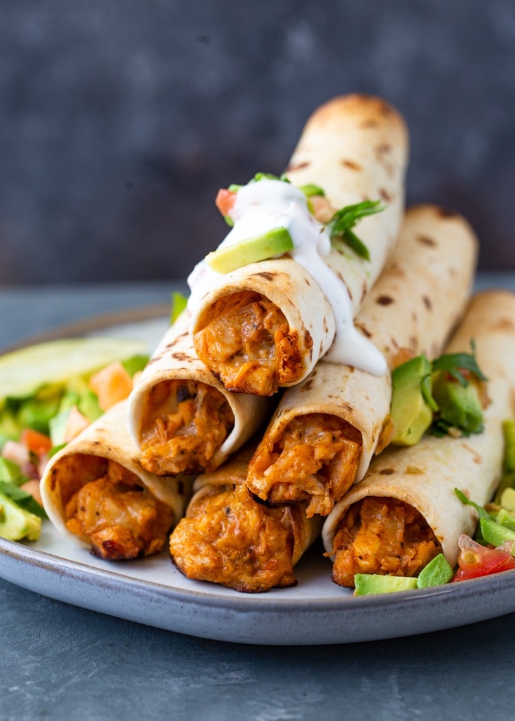 Homemade Air Fryer Chicken Taquitos on a tray with parchment paper