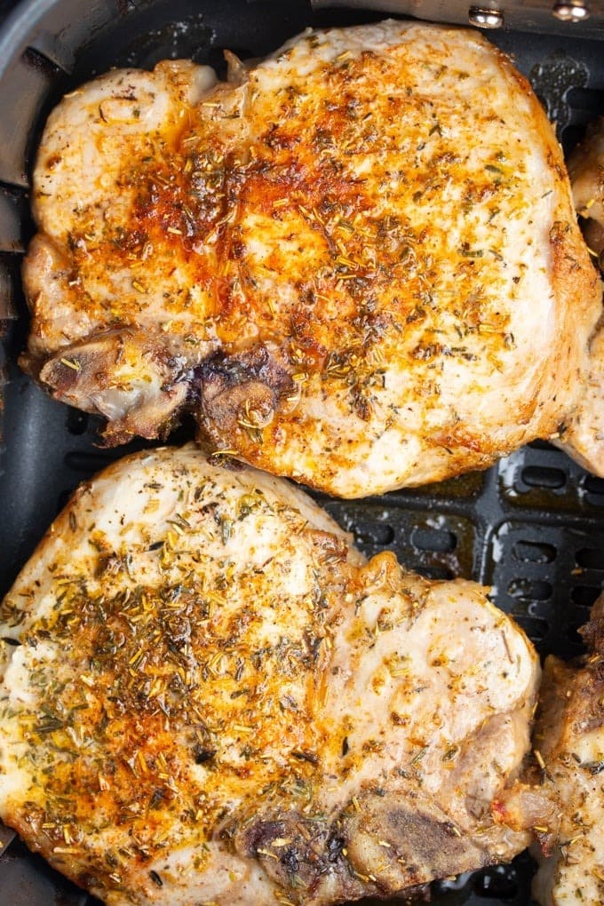 Seasoned pork chops in air fryer.