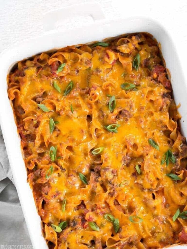 Cheesy beef and mushroom country casserole  garnished with chopped onion leeks.