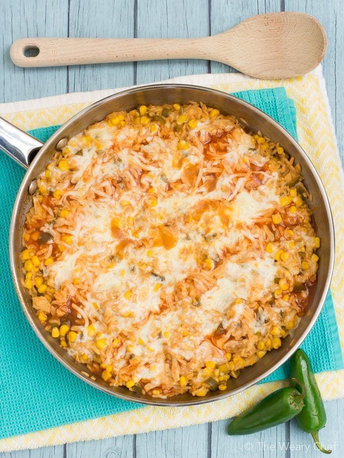Chicken Enchilada Skillet on a pan with fresh chilis on the side
