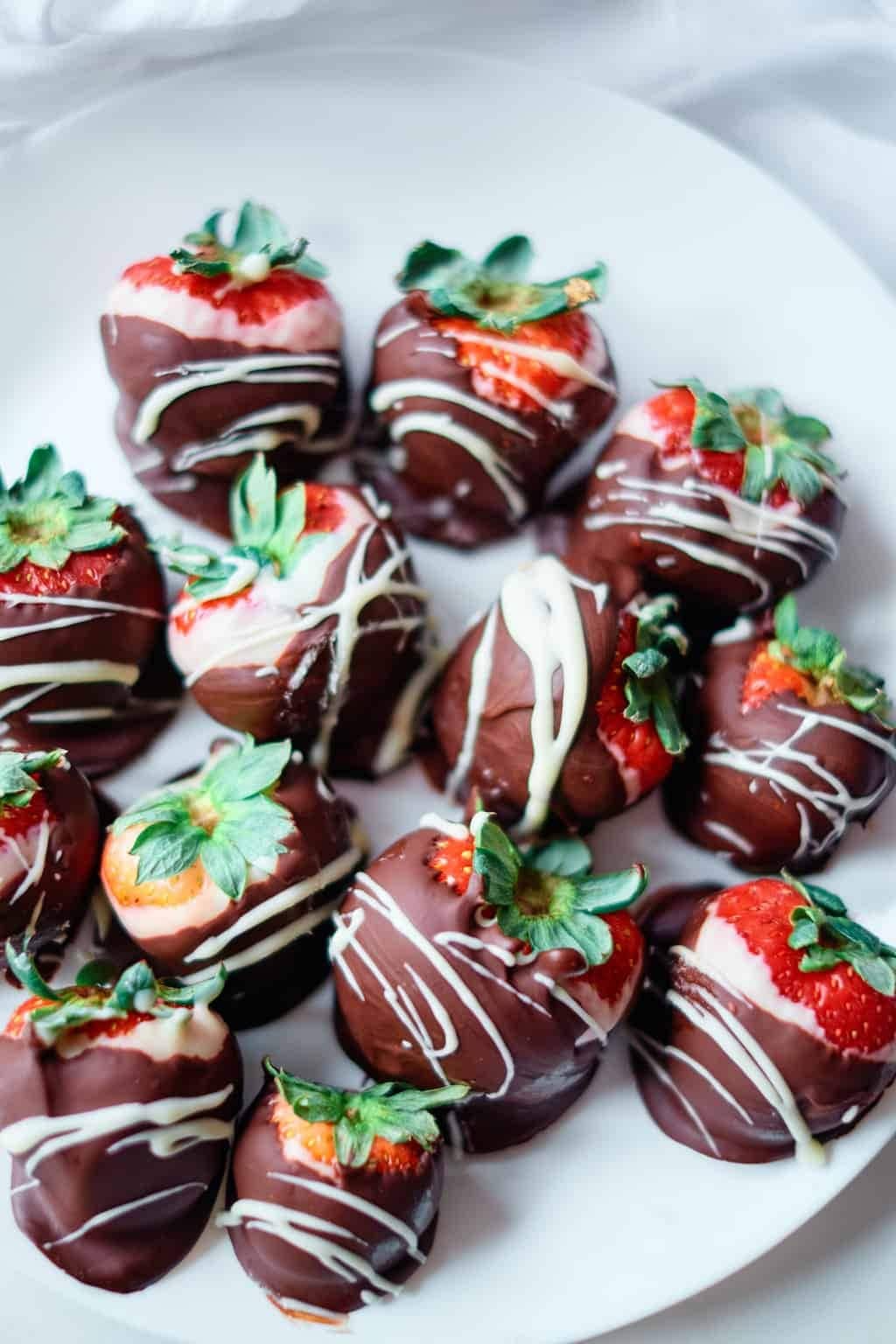 Plate with chocolate covered strawberries.