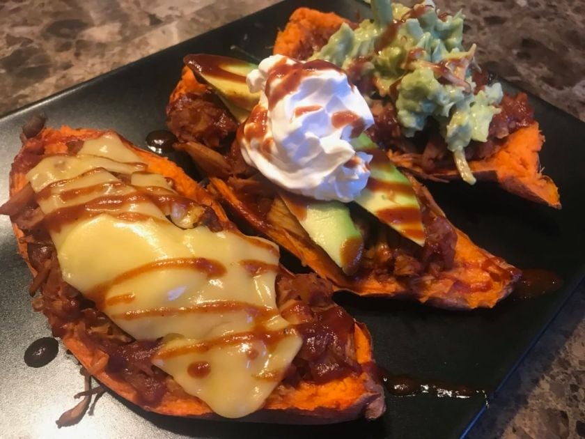 Jackfruit stuffed sweet potato topped with syrup.