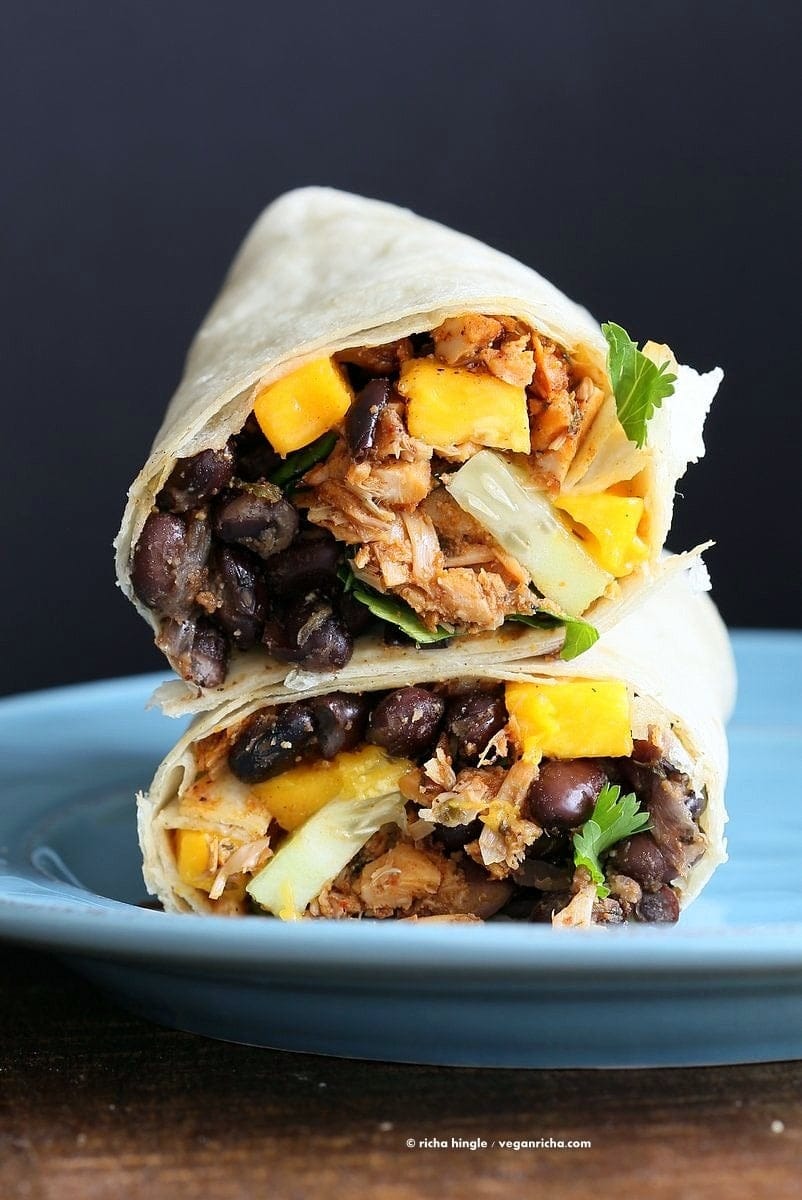 Wrap sliced in half with Jamaican jerk jackfruit caribbean black bean mango.