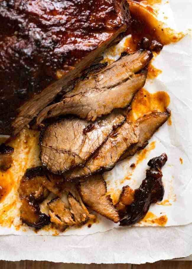 Sliced beef brisket with sauce.
