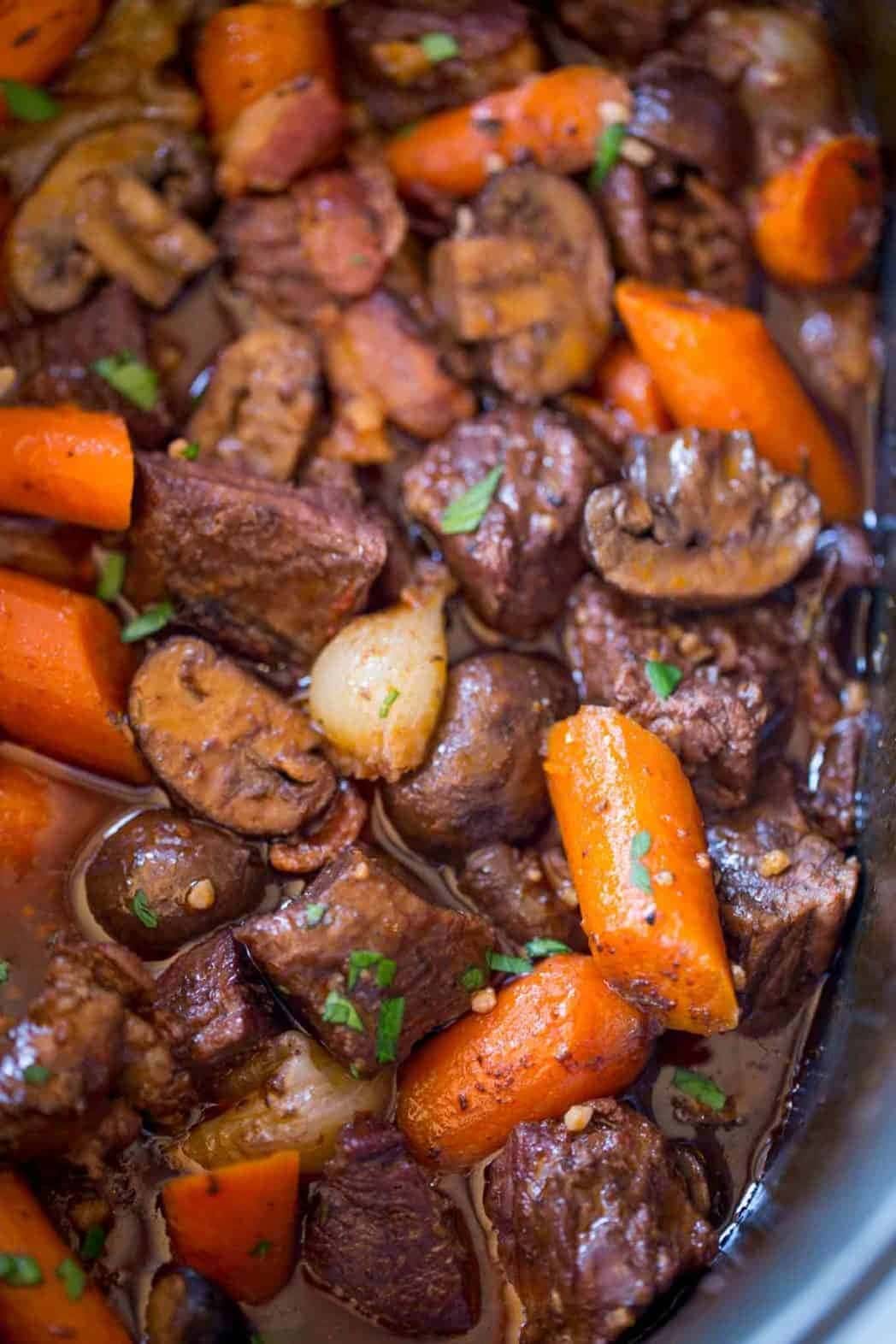 Slow Cooker Beef Bourguignon mushrooms, carrots, half the bacon, tomato paste, garlic, thyme, bay leaf, pearl onions and red wine