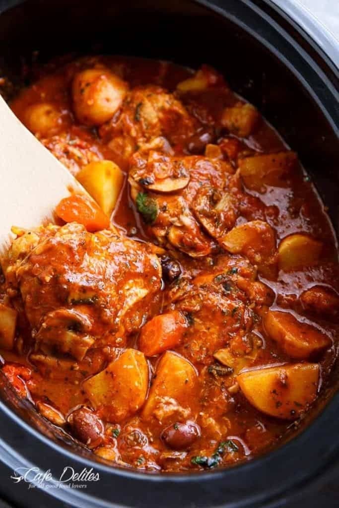 Slow Cooker Chicken Cacciatore with carrots, potatoes, black olives, crushed tomatoes, sliced mushrooms and red pepper flakes