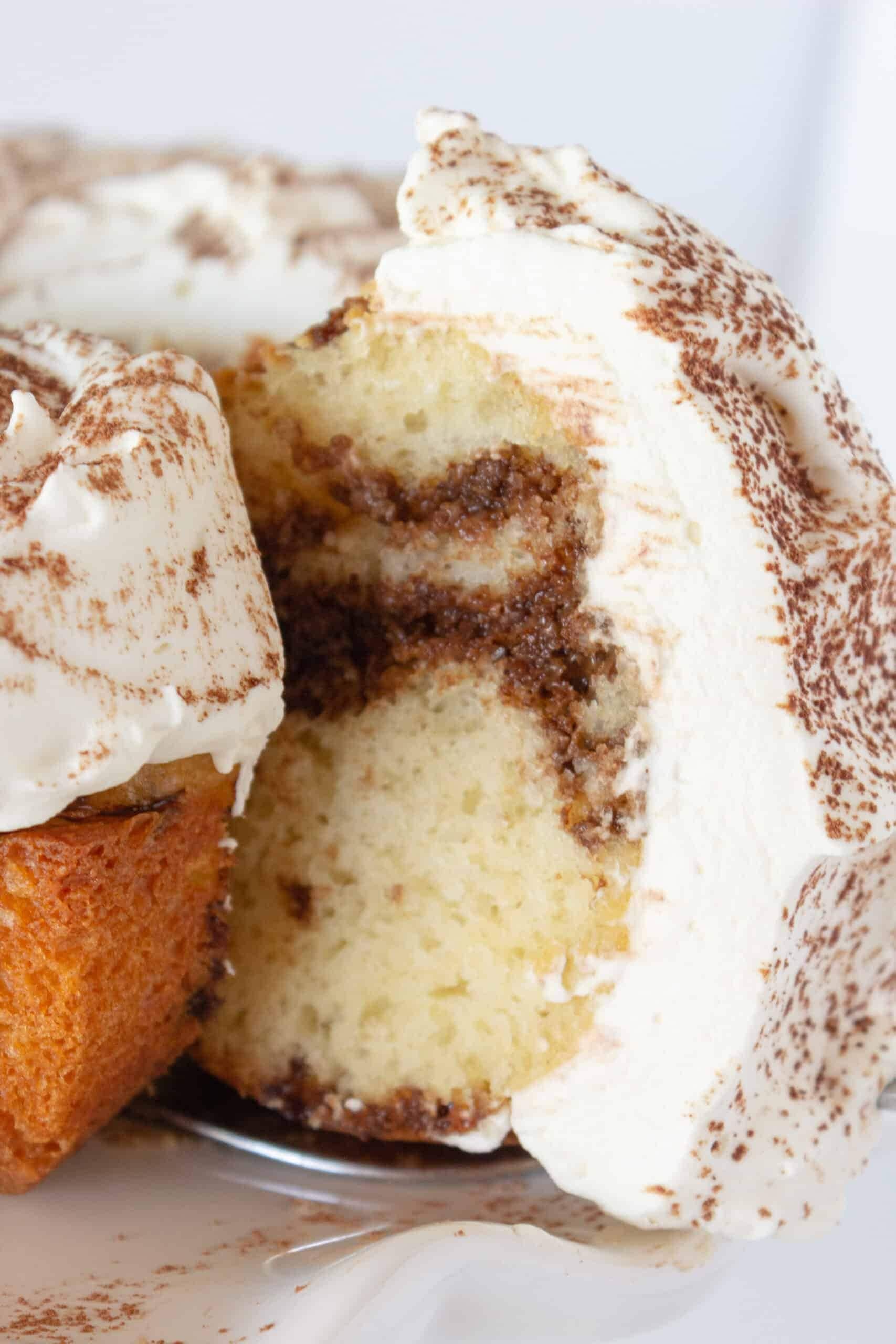 Sliced portion of a tiramisu bundt cake with icing