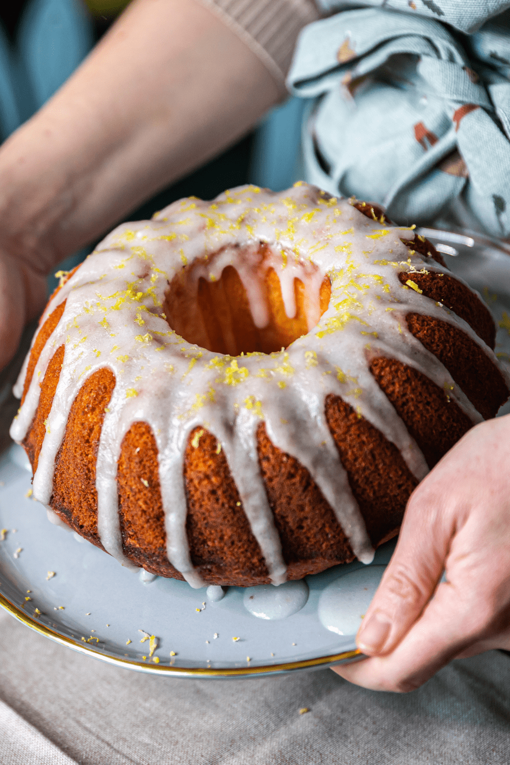 Woman Holding a Lemon Bundt Cake