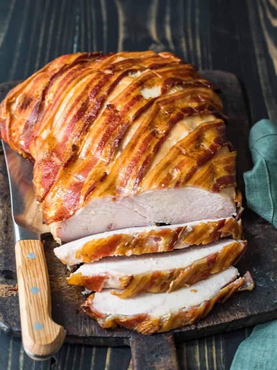 Sliced baked bacon wrapped turkey breast.