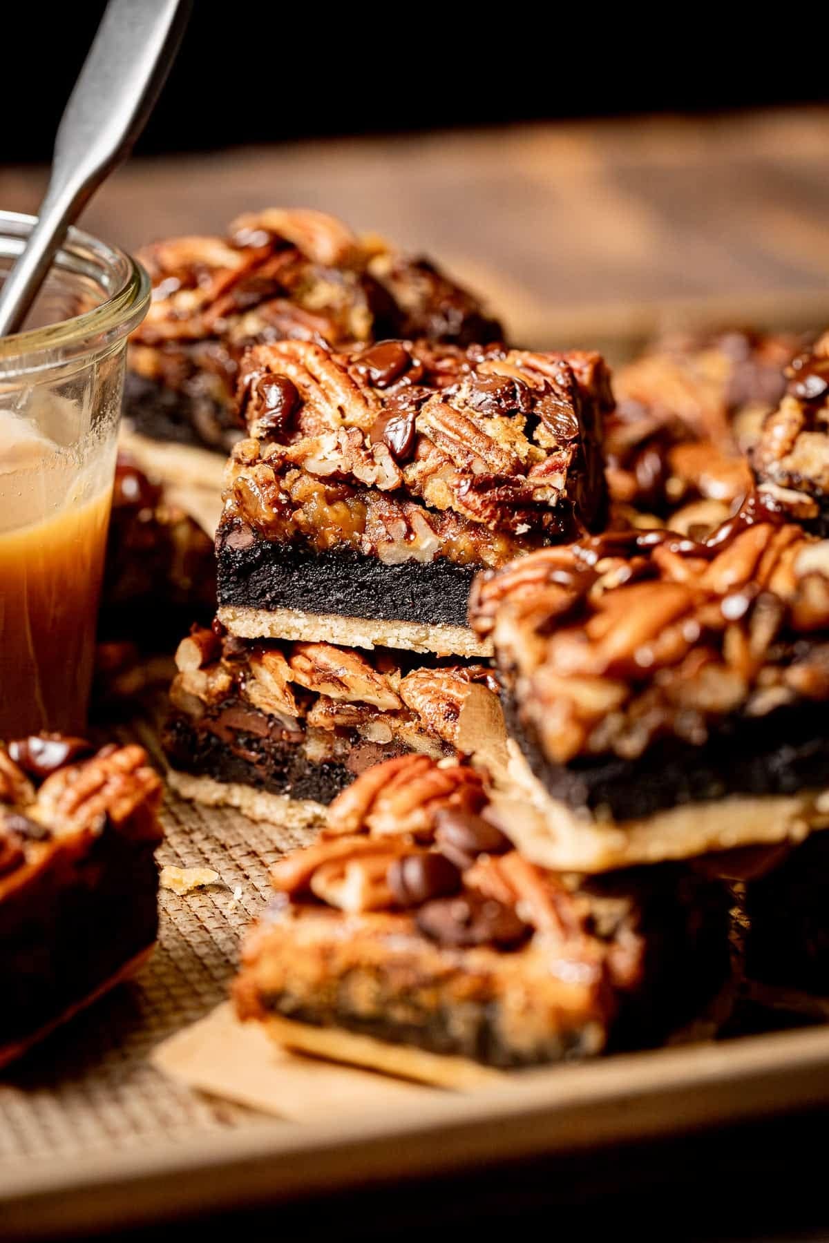 Brownies made with buttery shortbread crust, gooey brownie, and plenty of pecan on top.