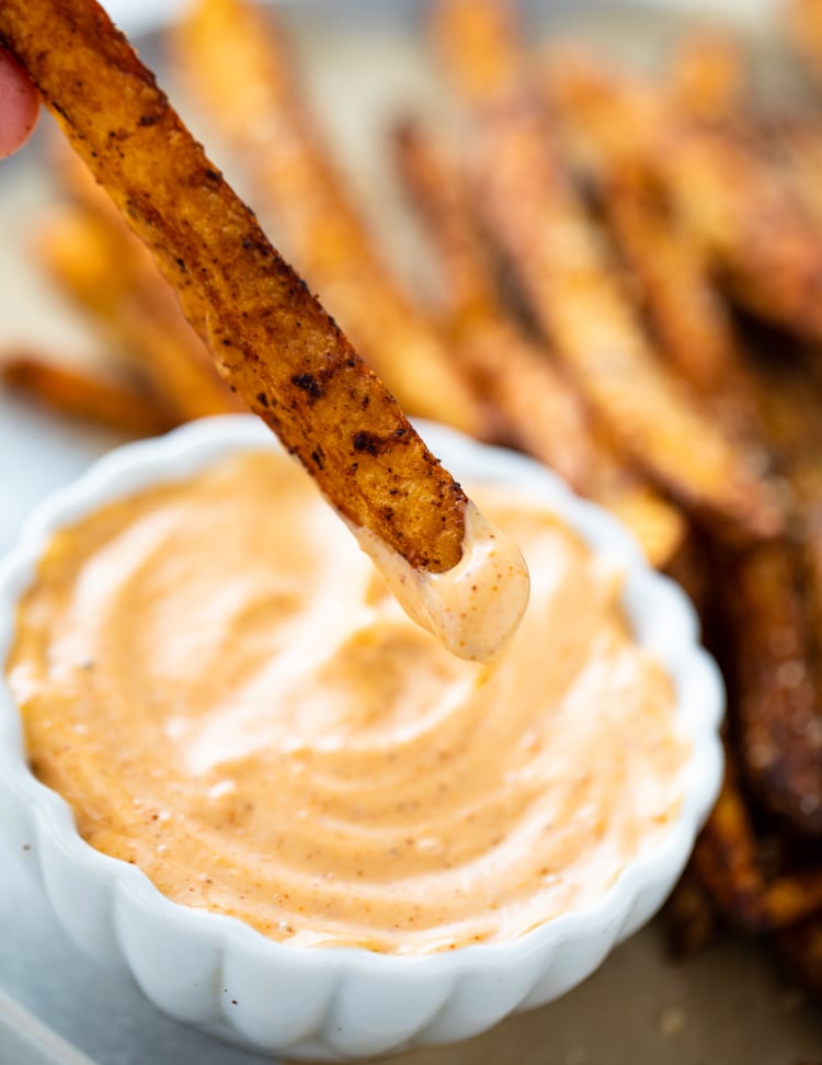 A piece of fries with spicy mayo