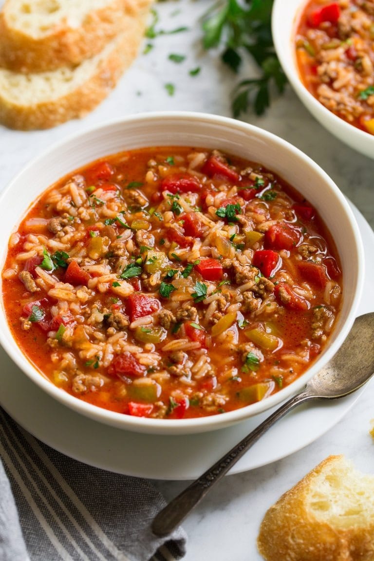 Bowl of homemade Stuffed Pepper Soup on a table sliced bread